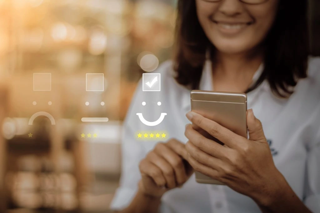 a woman is on her ell phone selecting highly satisfied customer rating